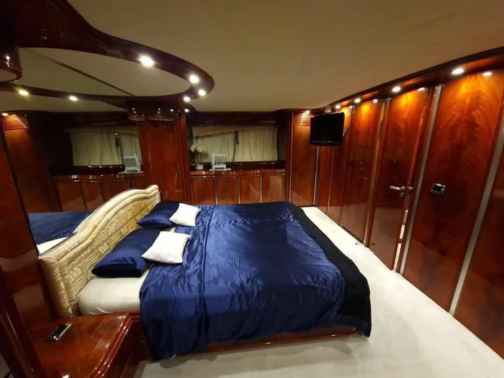  Yacht Photos Pics Luxurious bedroom interior on 2000 Astondoa 82 GLX yacht with elegant wood paneling.
