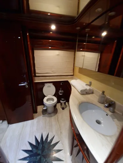  Yacht Photos Pics Luxurious bathroom in 2000 Astondoa 82 GLX yacht with elegant fixtures and marble flooring.