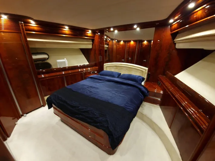  Yacht Photos Pics Luxurious bedroom interior of 2000 Astondoa 82 GLX yacht with elegant wood finish.