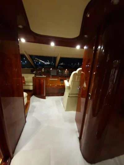  Yacht Photos Pics Luxurious interior of 2000 Astondoa 82 GLX yacht with polished wood and leather seating.