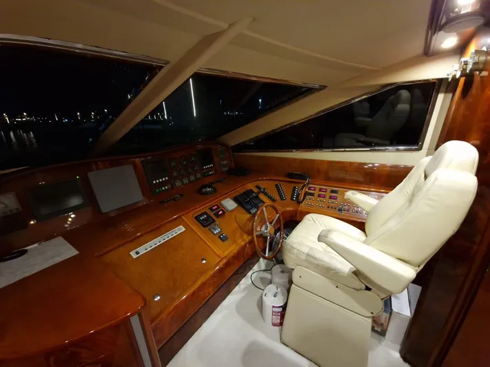  Yacht Photos Pics Luxurious Astondoa 82 GLX yacht cockpit with elegant wood finish and plush captain's chair.