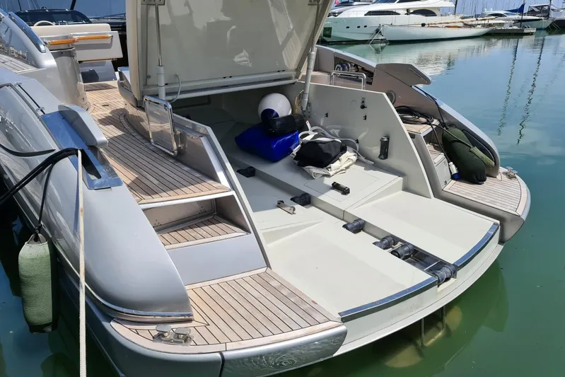 Infinity Yacht Photos Pics 2008 Riva 52 LE yacht with open deck, docked in a marina.