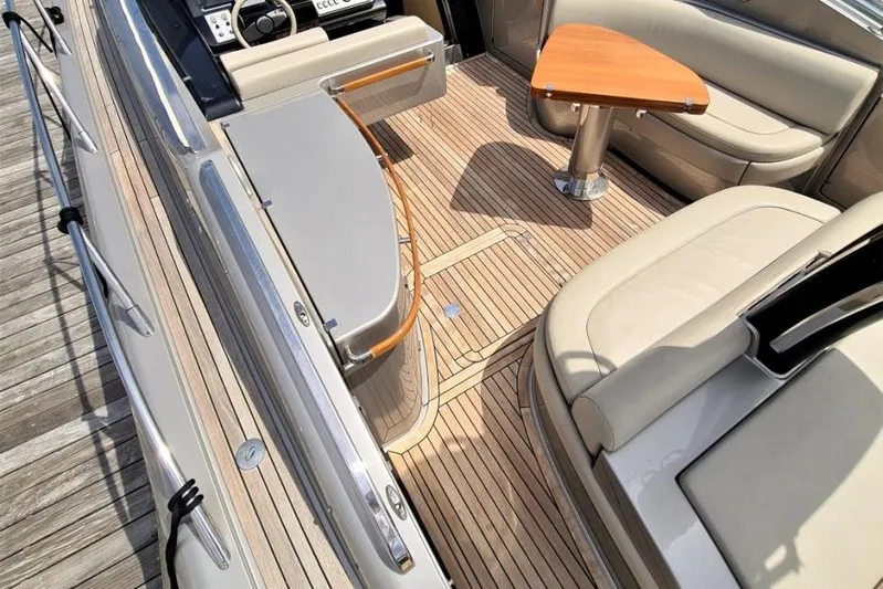 Infinity Yacht Photos Pics Luxurious 2008 Riva 52 LE yacht interior with elegant seating and wooden flooring.