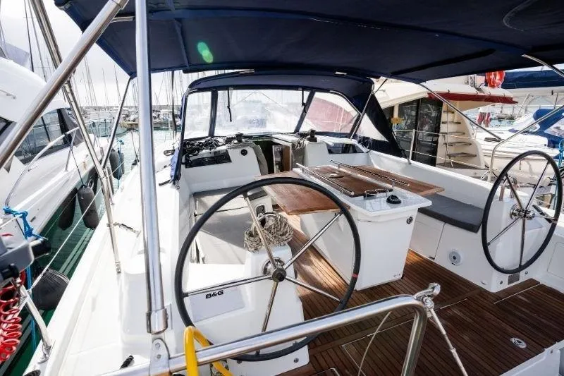  Yacht Photos Pics 2021 Beneteau Oceanis 40.1 yacht cockpit with dual steering wheels and wooden deck.