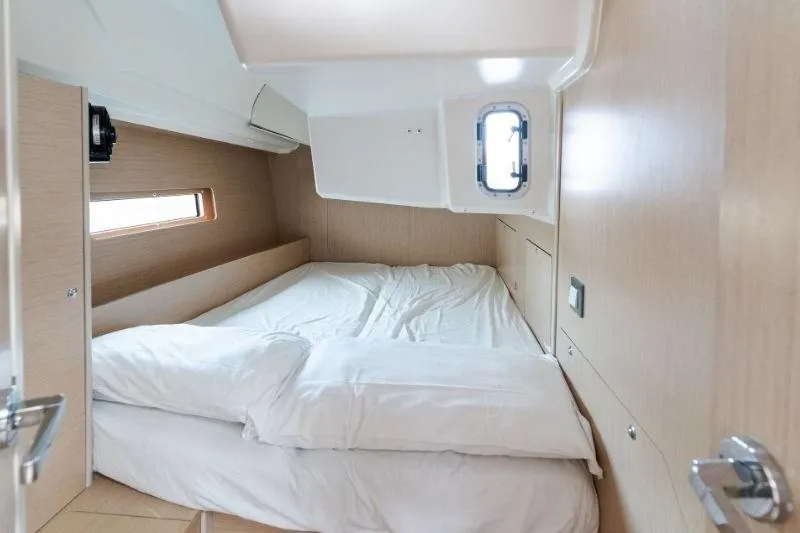  Yacht Photos Pics Cozy cabin interior of 2021 Beneteau Oceanis 40.1 yacht with comfortable bedding.