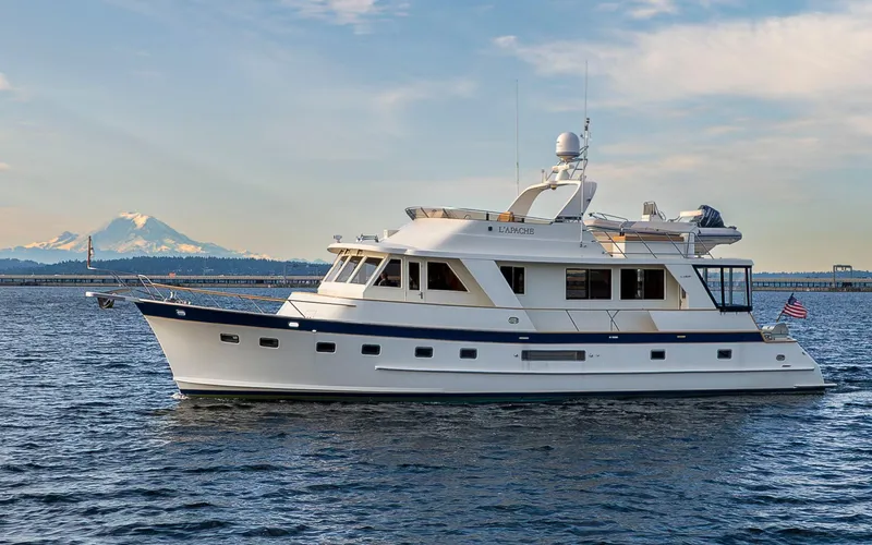 L'apache Yacht Photos Pics 2006 Alaskan 65 Flushdeck yacht on water with mountain backdrop.