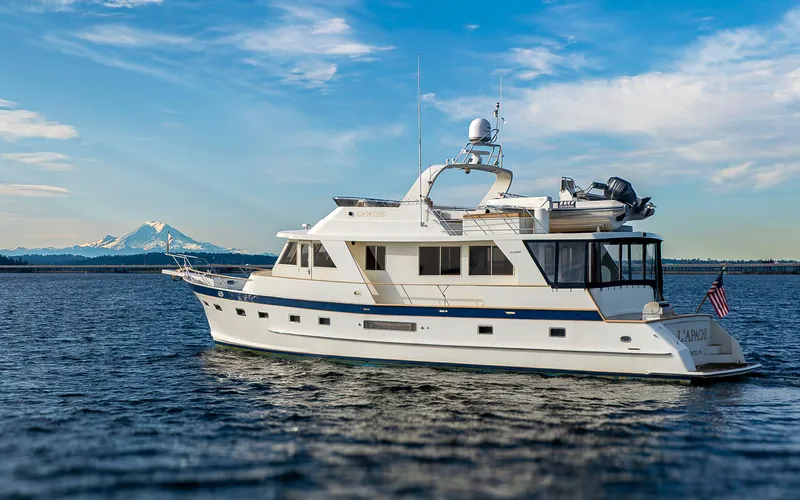 L'apache Yacht Photos Pics 2006 Alaskan 65 Flushdeck yacht on open water with mountain backdrop.