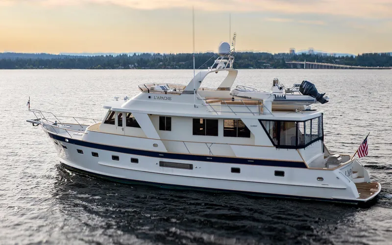L'apache Yacht Photos Pics 2006 Alaskan 65 Flushdeck yacht cruising on calm waters at sunset.