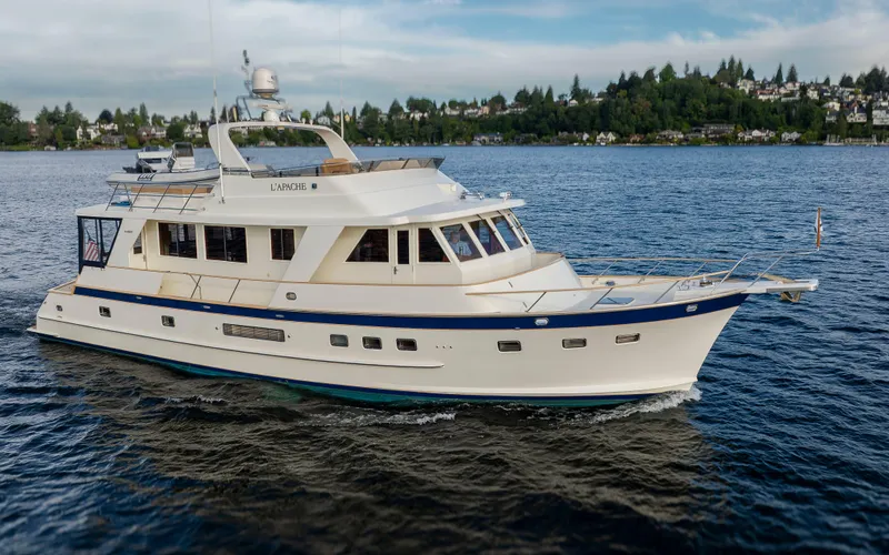 L'apache Yacht Photos Pics 2006 Alaskan 65 Flushdeck yacht cruising on a scenic lake with lush shoreline.