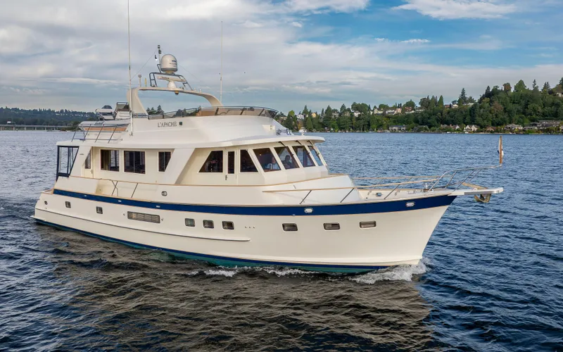 L'apache Yacht Photos Pics 2006 Alaskan 65 Flushdeck yacht cruising on a scenic lake with lush shoreline.