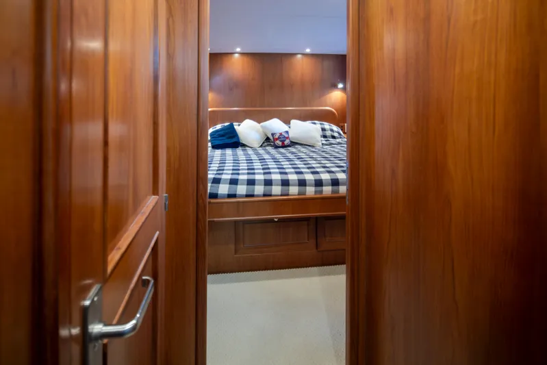 L'apache Yacht Photos Pics Luxurious cabin interior of 2006 Alaskan 65 Flushdeck yacht with cozy bed and wooden finish.