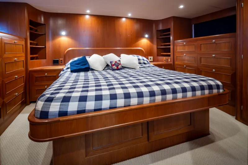 L'apache Yacht Photos Pics Luxurious bedroom in 2006 Alaskan 65 Flushdeck yacht with wood paneling and checkered bedding.
