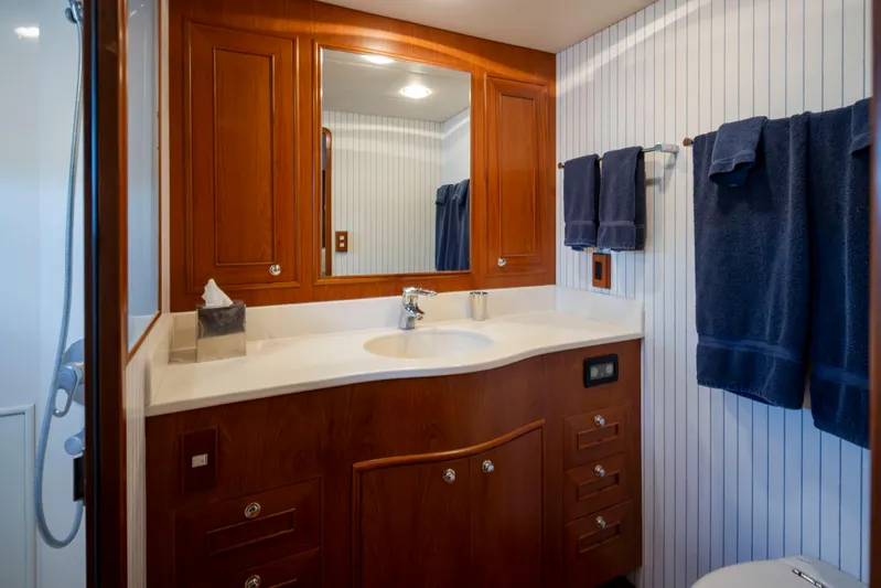 L'apache Yacht Photos Pics Luxurious bathroom in 2006 Alaskan 65 Flushdeck yacht with wood cabinetry and blue towels.