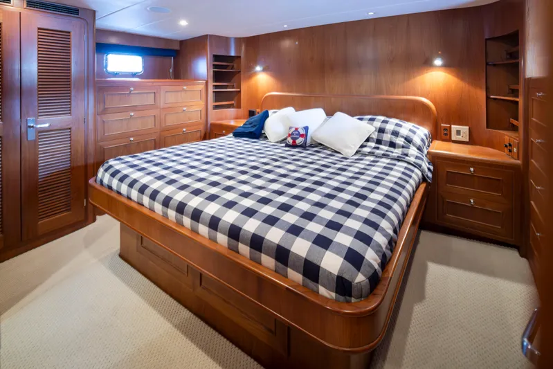 L'apache Yacht Photos Pics Luxurious bedroom in 2006 Alaskan 65 Flushdeck yacht with checkered bedding and wooden cabinetry.