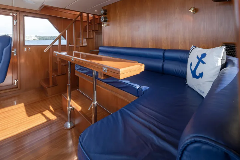 L'apache Yacht Photos Pics Luxurious interior of 2006 Alaskan 65 Flushdeck yacht with blue seating and nautical decor.