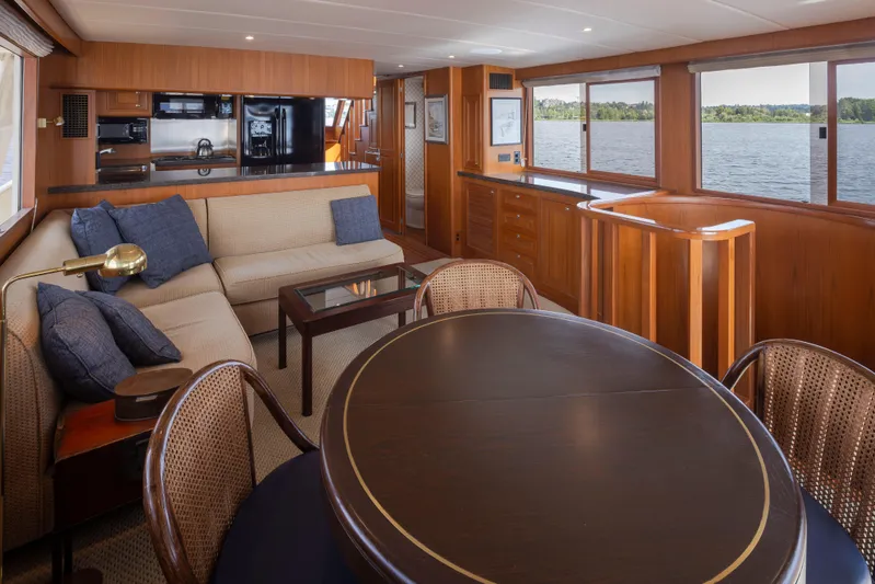 L'apache Yacht Photos Pics Luxurious interior of 2006 Alaskan 65 Flushdeck yacht with elegant wood finishes and comfortable seating.