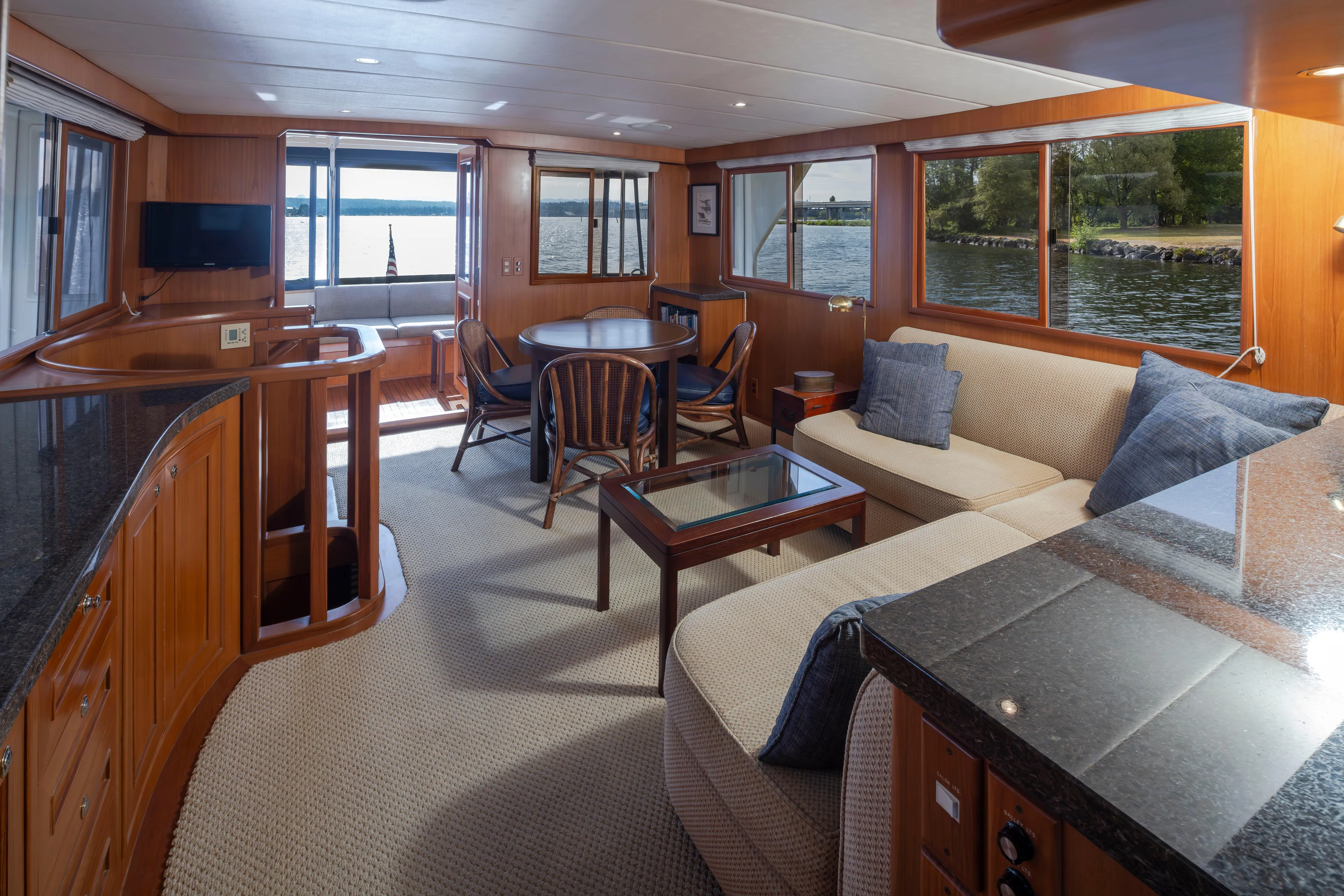 L'apache Yacht Photos Pics Luxurious interior of 2006 Alaskan 65 Flushdeck yacht with elegant wood finishes and waterfront views.