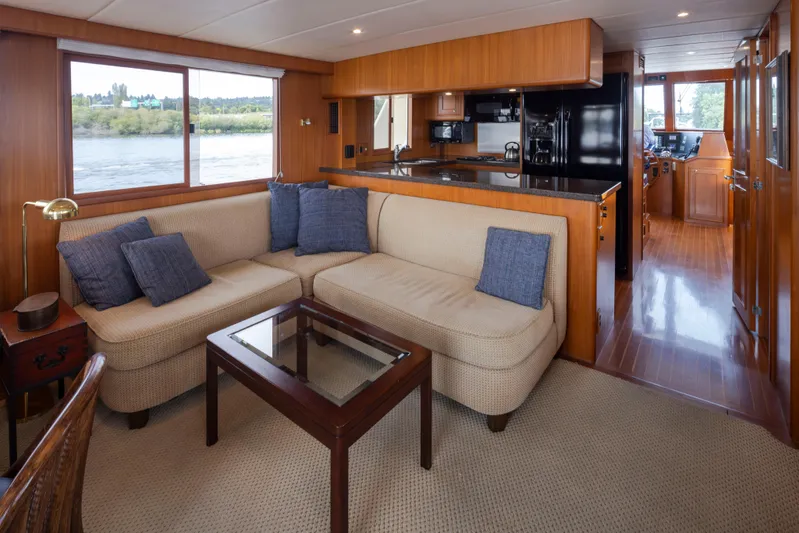 L'apache Yacht Photos Pics Luxurious interior of 2006 Alaskan 65 Flushdeck yacht with cozy seating and modern kitchen.
