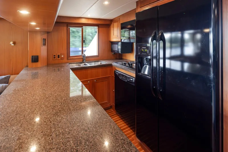L'apache Yacht Photos Pics Luxurious kitchen interior of 2006 Alaskan 65 Flushdeck yacht with granite countertops and modern appliances.