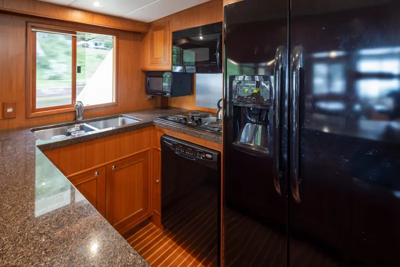 L'apache Yacht Photos Pics Luxurious kitchen in 2006 Alaskan 65 Flushdeck yacht with modern appliances and wood cabinetry.