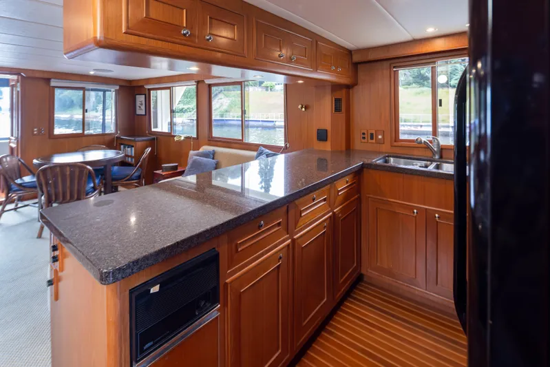 L'apache Yacht Photos Pics Luxurious 2006 Alaskan 65 Flushdeck yacht interior with elegant wood cabinetry and spacious dining area.