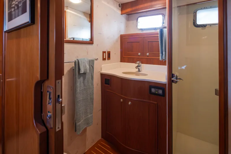 L'apache Yacht Photos Pics Bathroom interior of 2006 Alaskan 65 Flushdeck yacht with wooden cabinetry and shower.