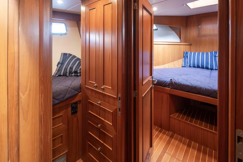 L'apache Yacht Photos Pics Interior of 2006 Alaskan 65 Flushdeck yacht with wooden finish and cozy bedrooms.