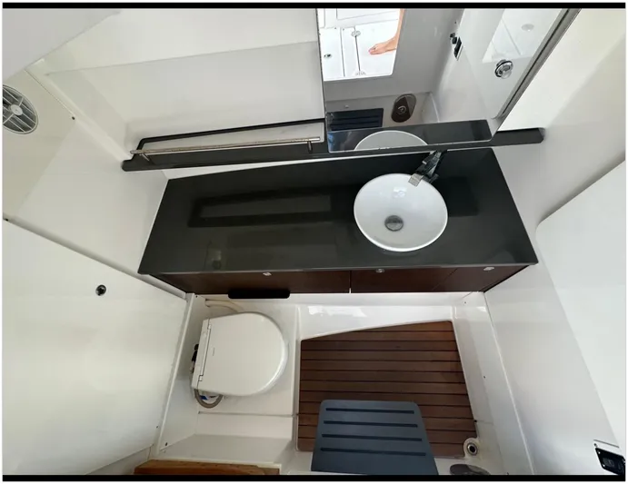  Yacht Photos Pics 2019 Everglades 340 DC boat bathroom with sink, toilet, and wooden floor.