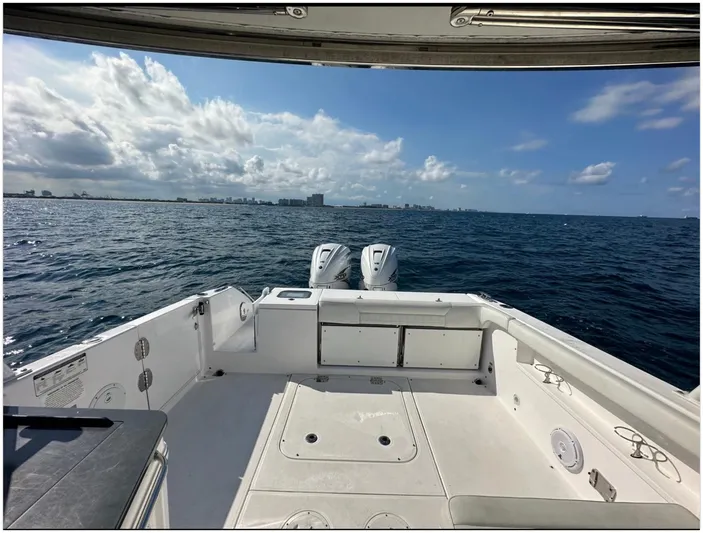  Yacht Photos Pics 2019 Everglades 340 DC boat on open water, clear sky, city skyline in distance.