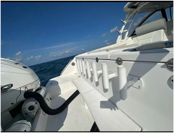  Yacht Photos Pics 2019 Everglades 340 DC boat with rod holders, ocean view, and clear blue sky.