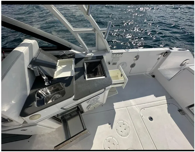  Yacht Photos Pics 2019 Everglades 340 DC boat interior with sink and grill, overlooking ocean water.