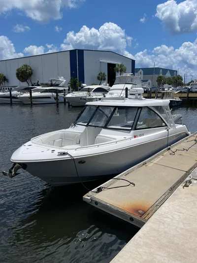  Yacht Photos Pics 2019 Everglades 340 DC boat docked at marina under blue sky.