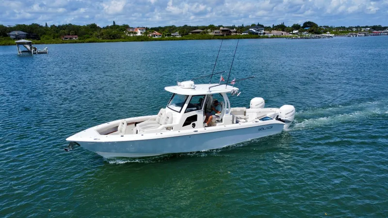 Mermaiden Yacht Photos Pics 2020 Solace 345 boat cruising on a serene lake under a partly cloudy sky.