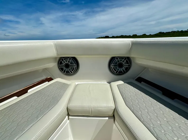Mermaiden Yacht Photos Pics Luxurious seating on 2020 Solace 345 boat with built-in speakers, under a clear blue sky.