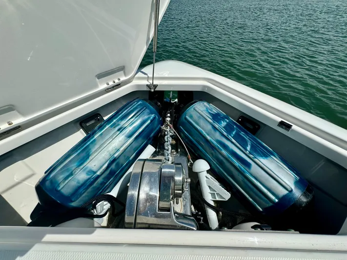 Mermaiden Yacht Photos Pics 2020 Solace 345 boat storage compartment with blue fenders and anchor, open on water.