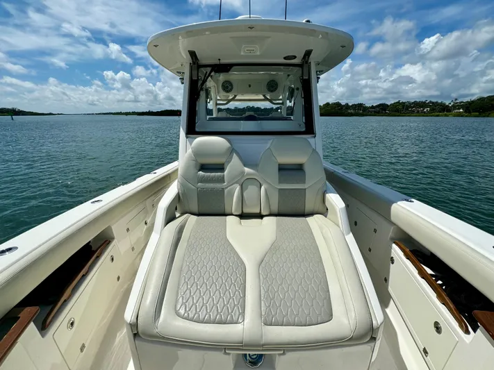 Mermaiden Yacht Photos Pics 2020 Solace 345 boat with cushioned seating on a calm lake.