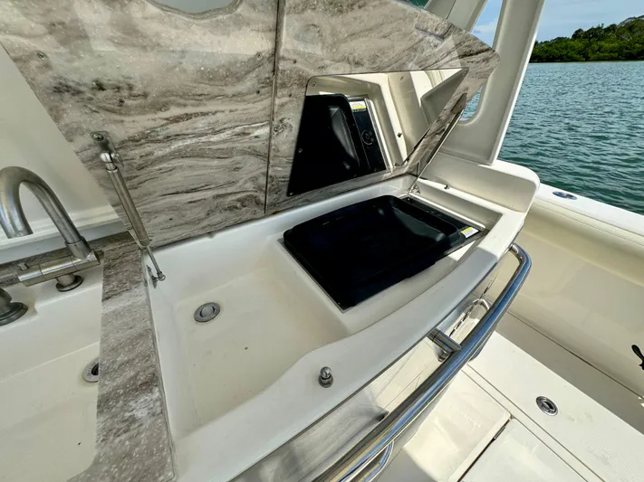 Mermaiden Yacht Photos Pics Luxury boat kitchen area with marble countertop, sink, and scenic water view. Solace 345, 2020 model.