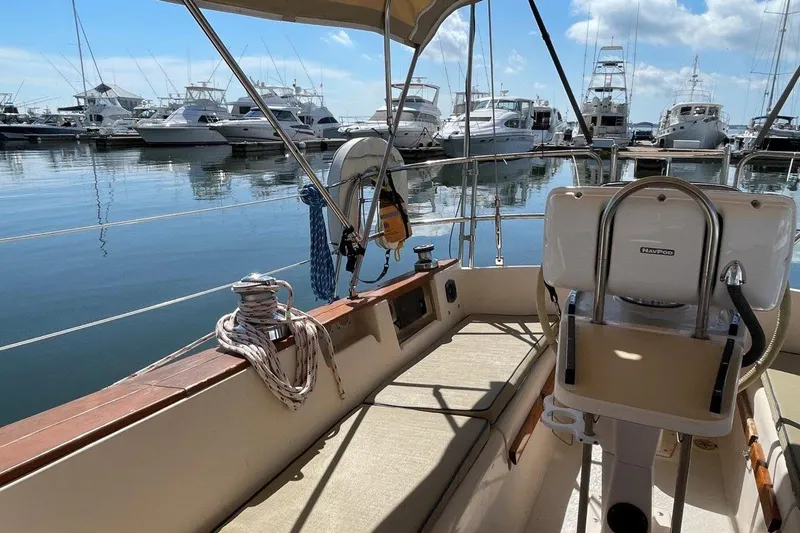 Dream Flower Yacht Photos Pics Cockpit view of a 1995 Island Packet 40 sailboat docked in a marina.