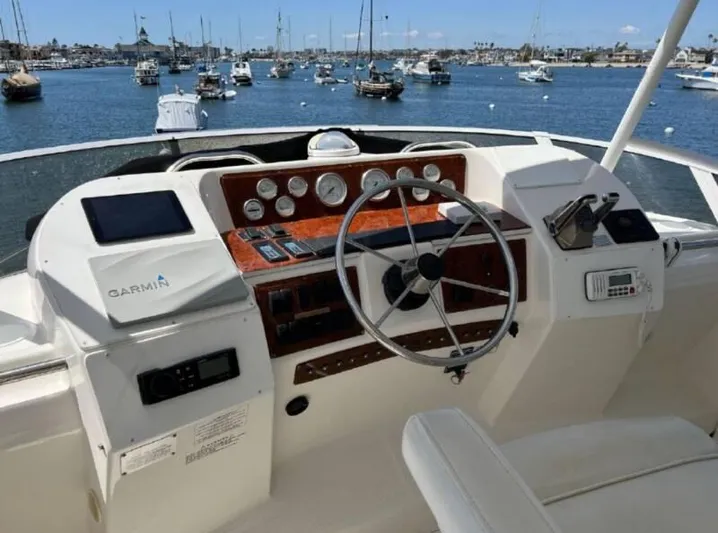  Yacht Photos Pics 2000 Silverton 453 Motor Yacht helm with Garmin navigation, overlooking marina with sailboats.