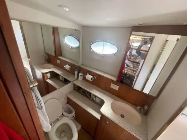 Yacht Photos Pics Bathroom interior of 2000 Silverton 453 Motor Yacht with sink, toilet, and mirror.
