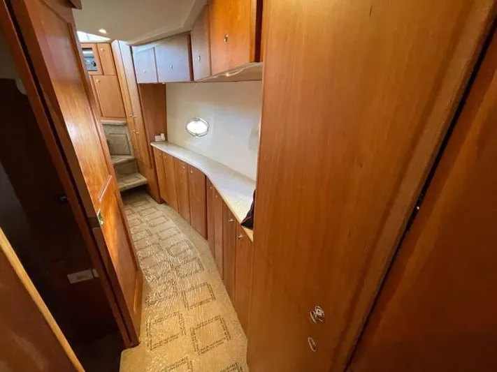 Yacht Photos Pics 2000 Silverton 453 Motor Yacht interior with wooden cabinetry and carpeted flooring.