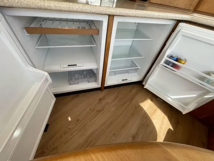  Yacht Photos Pics Empty refrigerator and freezer in 2000 Silverton 453 Motor Yacht kitchen area.