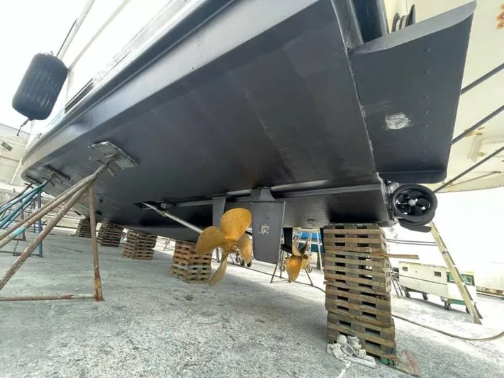  Yacht Photos Pics Underneath view of a 2000 Silverton 453 Motor Yacht on blocks, showing propellers and hull.