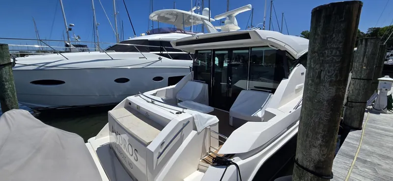 Andros Yacht Photos Pics 2016 Tiara Yachts C44 Coupe docked at marina, sunny day.
