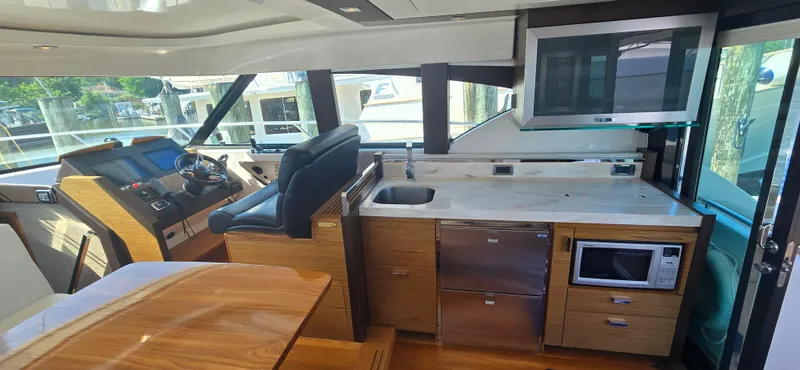 Andros Yacht Photos Pics Interior of 2016 Tiara Yachts C44 Coupe with helm, kitchen, and modern amenities.