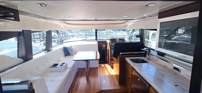 Andros Yacht Photos Pics Luxurious interior of 2016 Tiara Yachts C44 Coupe with modern seating and kitchen area.