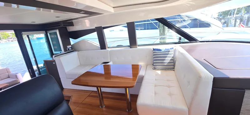 Andros Yacht Photos Pics Luxurious interior of 2016 Tiara Yachts C44 Coupe with elegant seating and wooden table.