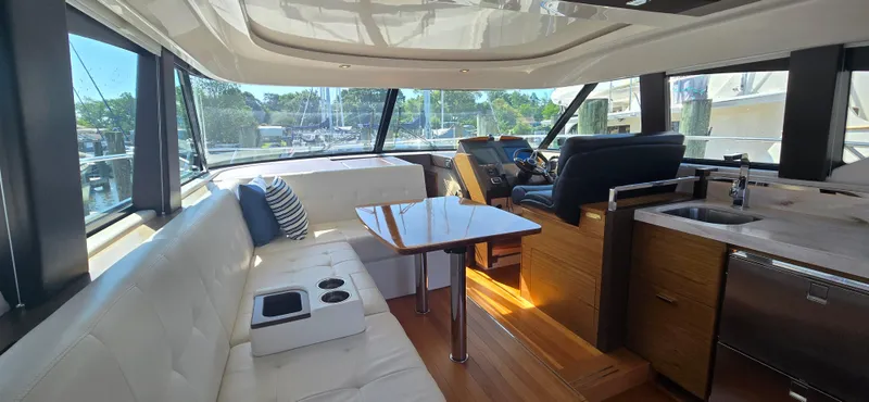Andros Yacht Photos Pics Luxurious interior of 2016 Tiara Yachts C44 Coupe with plush seating and modern helm.