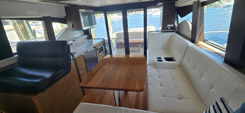 Andros Yacht Photos Pics Luxurious interior of 2016 Tiara Yachts C44 Coupe with elegant seating and scenic water view.