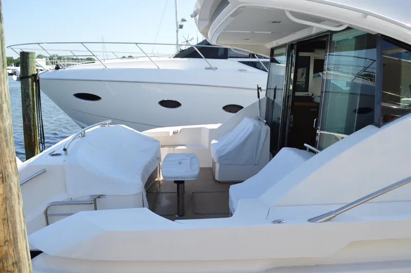 Andros Yacht Photos Pics 2016 Tiara Yachts C44 Coupe, docked with covered seating area and sleek design.